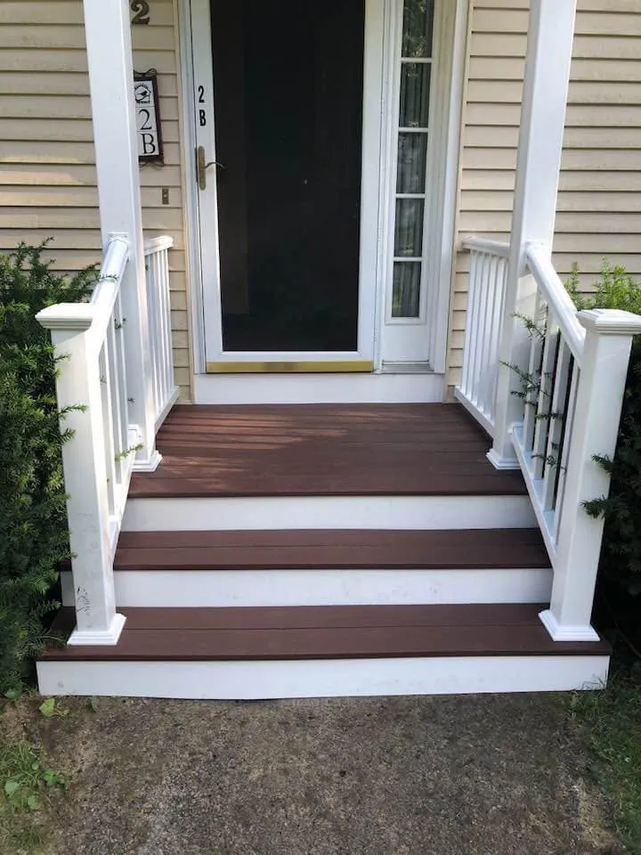 Finished front steps with composite treads and white railings