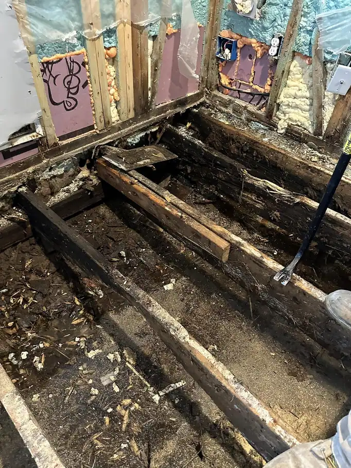Rotted floor framing opened up before repair
